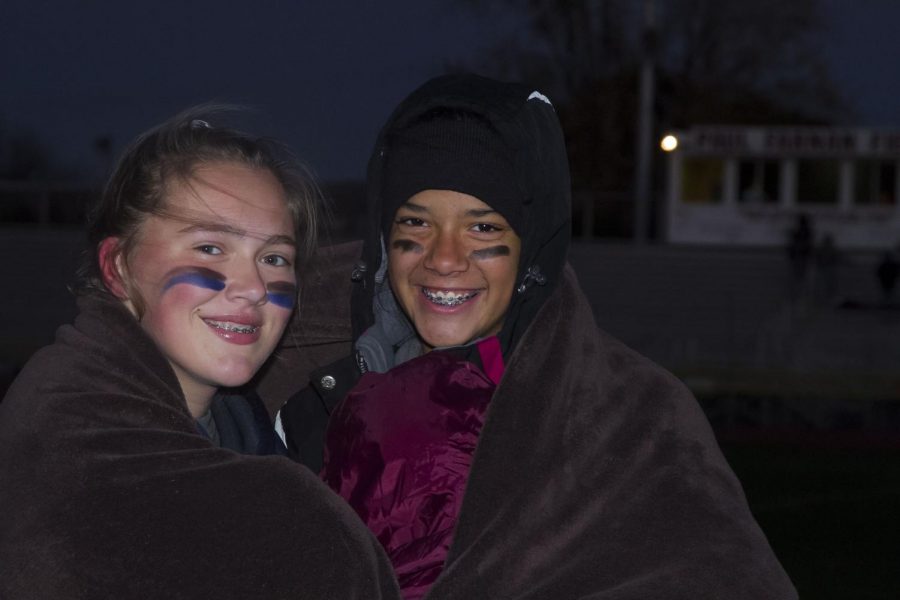 SMILE THROUGH THE COLD Freshmen Emma Rambo and Nikki Smith smile through the cold as they watch the games.