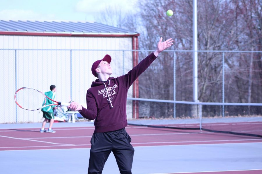 FOLLOW THROUGH! Senior Kyle Mabus throws the ball up and is ready for the first serve in a match against Pen Argyl. Mabus is a two-year player. 