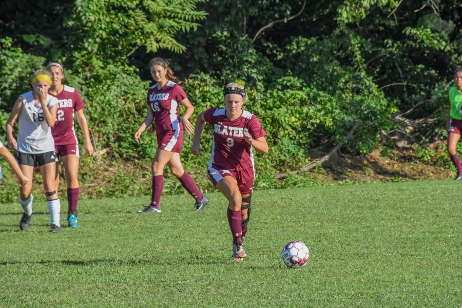 AGGRESSIVE! Senior Jenna Learn protects the ball as she runs  it to the goal. Learn earned 1st team for Colonial League honors.