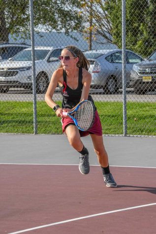 HUSTLE AND HEART   Junior Emilee Brewer uses her speed and agility to return her opponent’s difficult serve.   Partnered with Julia Dowd, Emilee Brewer had a phenomenal season. At the Colonial League Tournament, Brewer and Dowd placed third. 