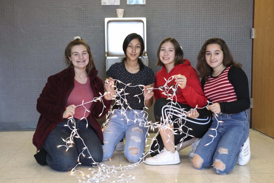 TOUGH LUCK! A few ladies from the freshman class work together to untangle the Christmas lights, so they can hang them up.