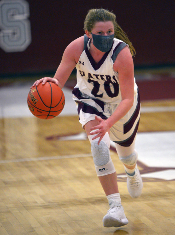 DRIBBLE, DRIBBLE, SHOOT! Senior Emma Stout speed dribbles her way across the court in search of the net. Stout’s unwavering dedication and love for the game made her the perfect addition to the starting lineup!  