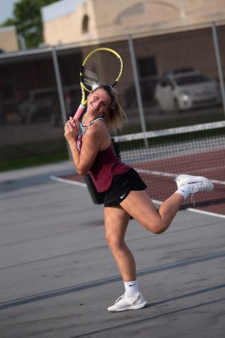 Just a Sec! Junior Alanie Fornaro stops to take a picture before going onto the court. 