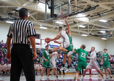 WATCH OUT! Junior Guard Josh Giaquinto soars above the competition to throw an acrobatic pass from under the basketball against rival Pen Argyl. Giaquinto led the Slaters with 17.9 PPG and 2.5 APG this season.  