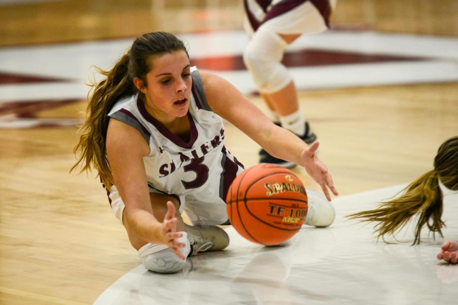 ALL IN! Sophomore Julia Pinter dives for a loose ball against Wilson in the season opener on December 14, 2022. Pinter had a breakout year, averaging 7.7 points and 2.5 rebounds per game in the final month of the season. 