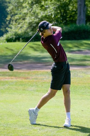 FORE! Senior Golfer Jake Constantine drives a ball the distance.