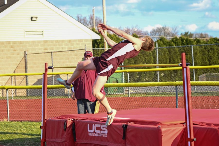 REACHING NEW HEIGHTS! Senior Justin McNeely gets high up too clear the bar.