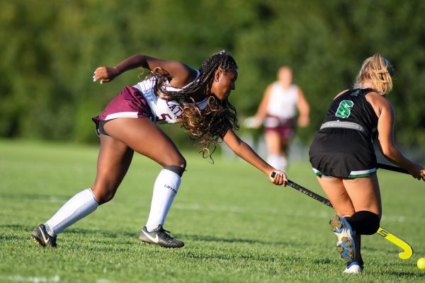 STANDOUT EFFORT
Senior Najae Vilmenay puts in a determined effort to stop the rival team from gaining possession of the ball in the field hockey match