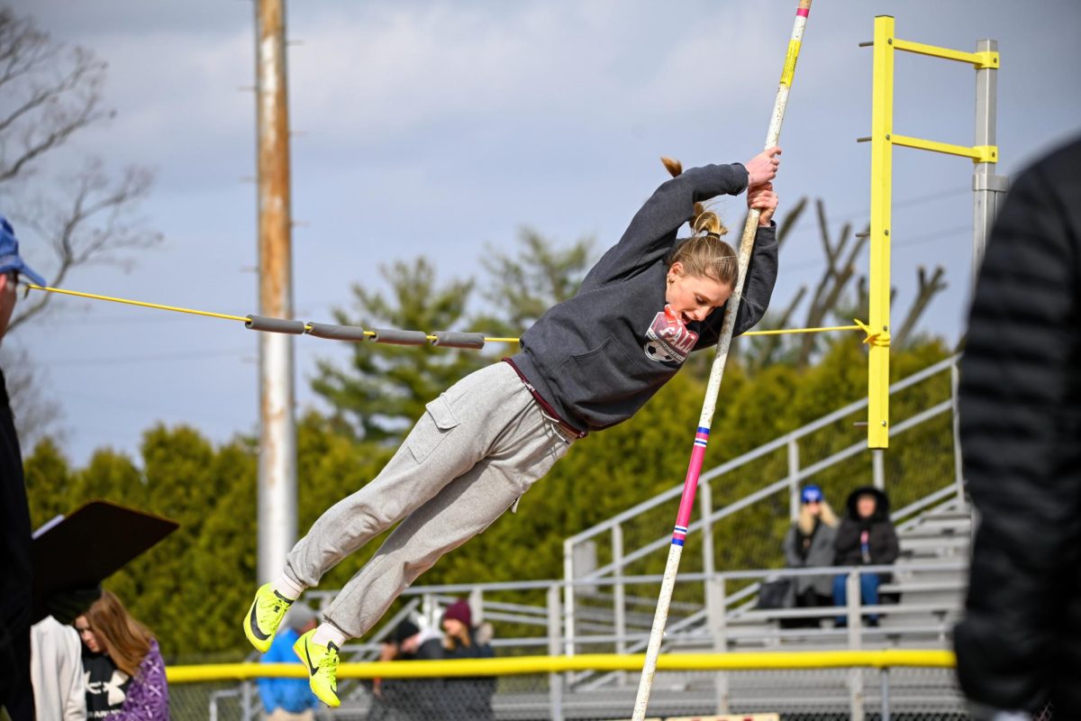 POLE VAULT PRECISION
Sophomore Raegan Toomey showcases her agility and skill as she executes a pole vault for the track and field team, displaying determination and athleticism in her impressive performance.
