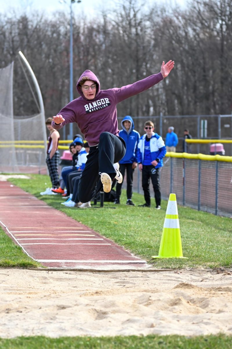 SOARING SOPHOMORE
Sophomore athlete Jacob Hillis displays impressive athleticism as he leaps into action during a captivating long jump contest.