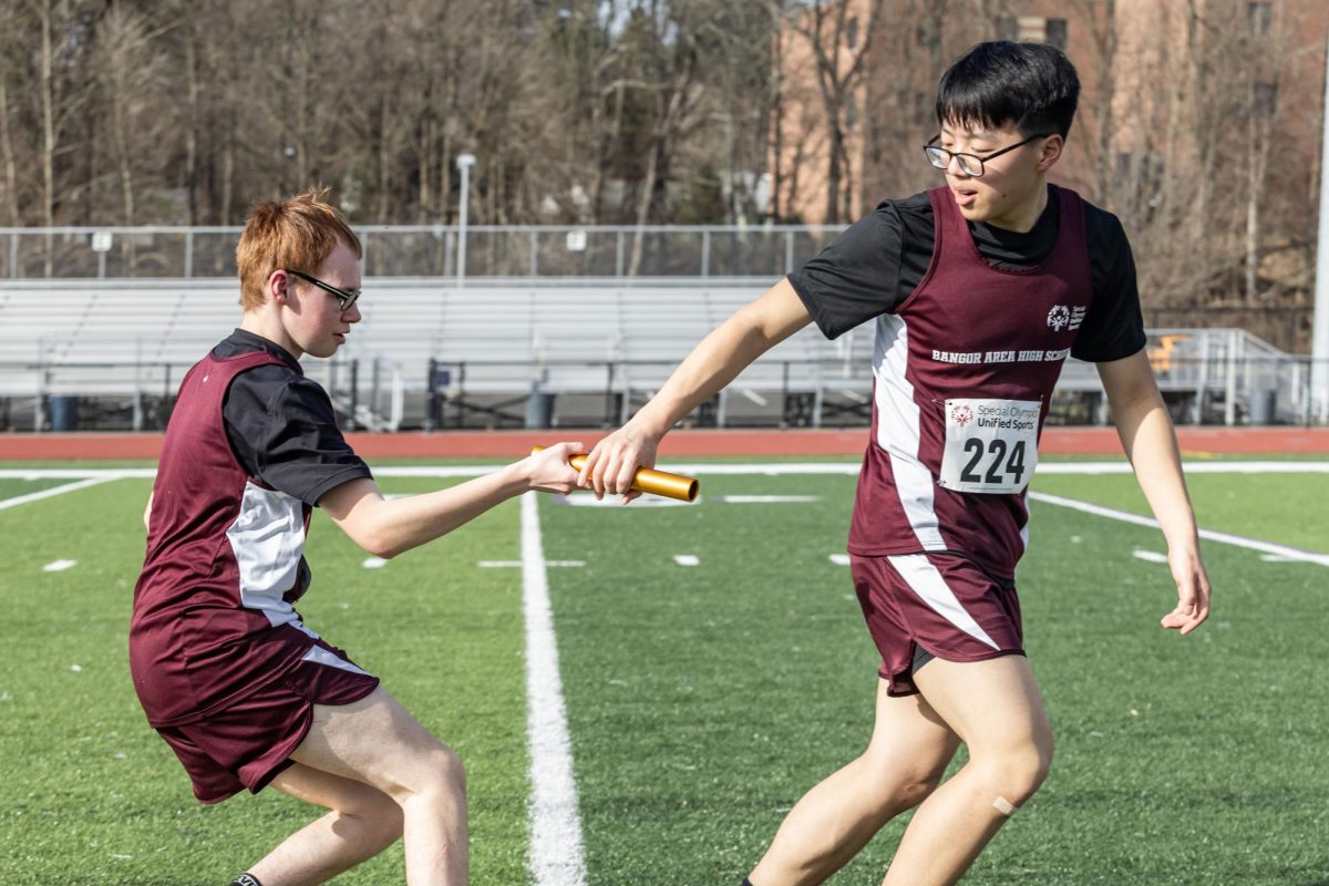 UNIFIED RELAY POWERHOUSE
Senior Devin Howell and Junior Tyler Naysmith exhibit seamless coordination as they participate in a thrilling baton pass race, showcasing their teamwork and athleticism on the track.