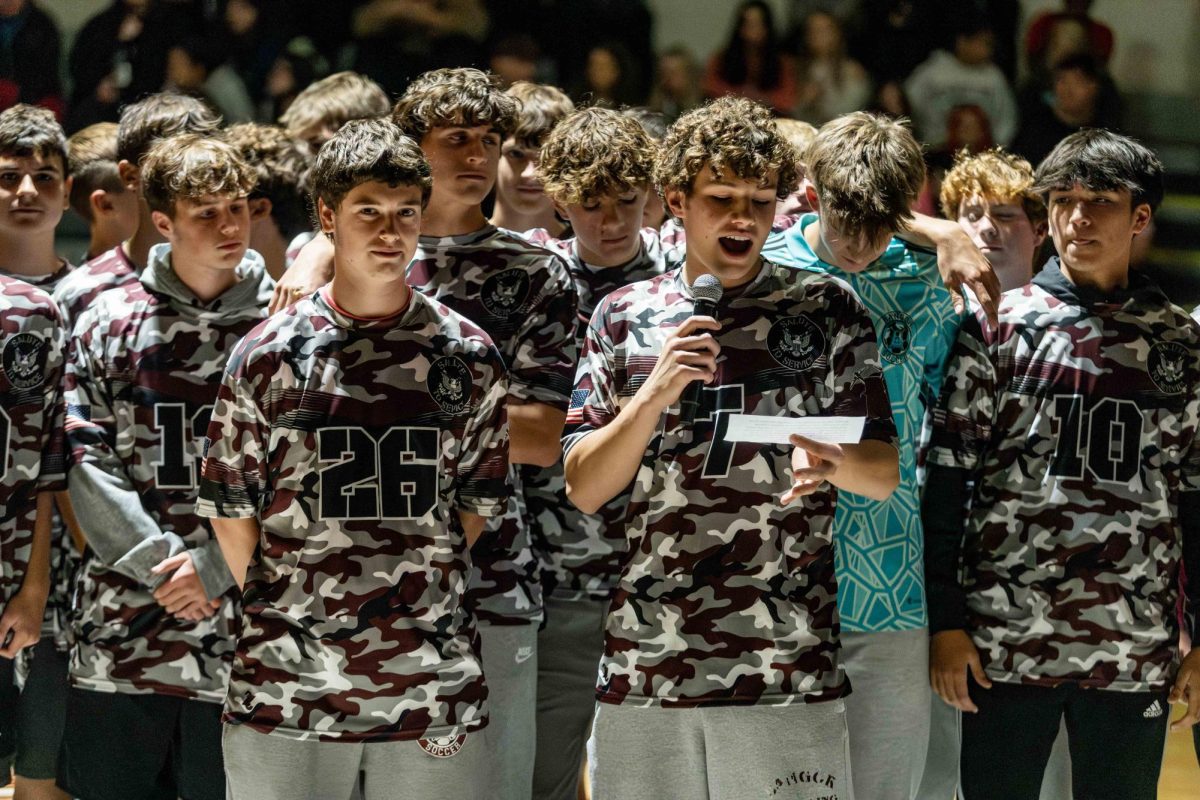 Standing as a team, Aiden McNulty tells the pep rally crowd about the boys soccer season and praises his teammates grit and determination. Slater soccer has a young team and high hopes for the future. We can all see that they love their sport. 